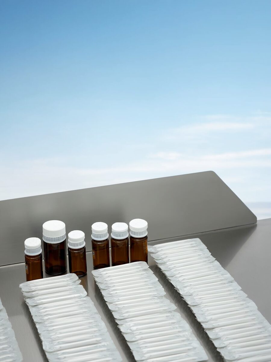 Medicine bottles and blister packs on a laboratory counter