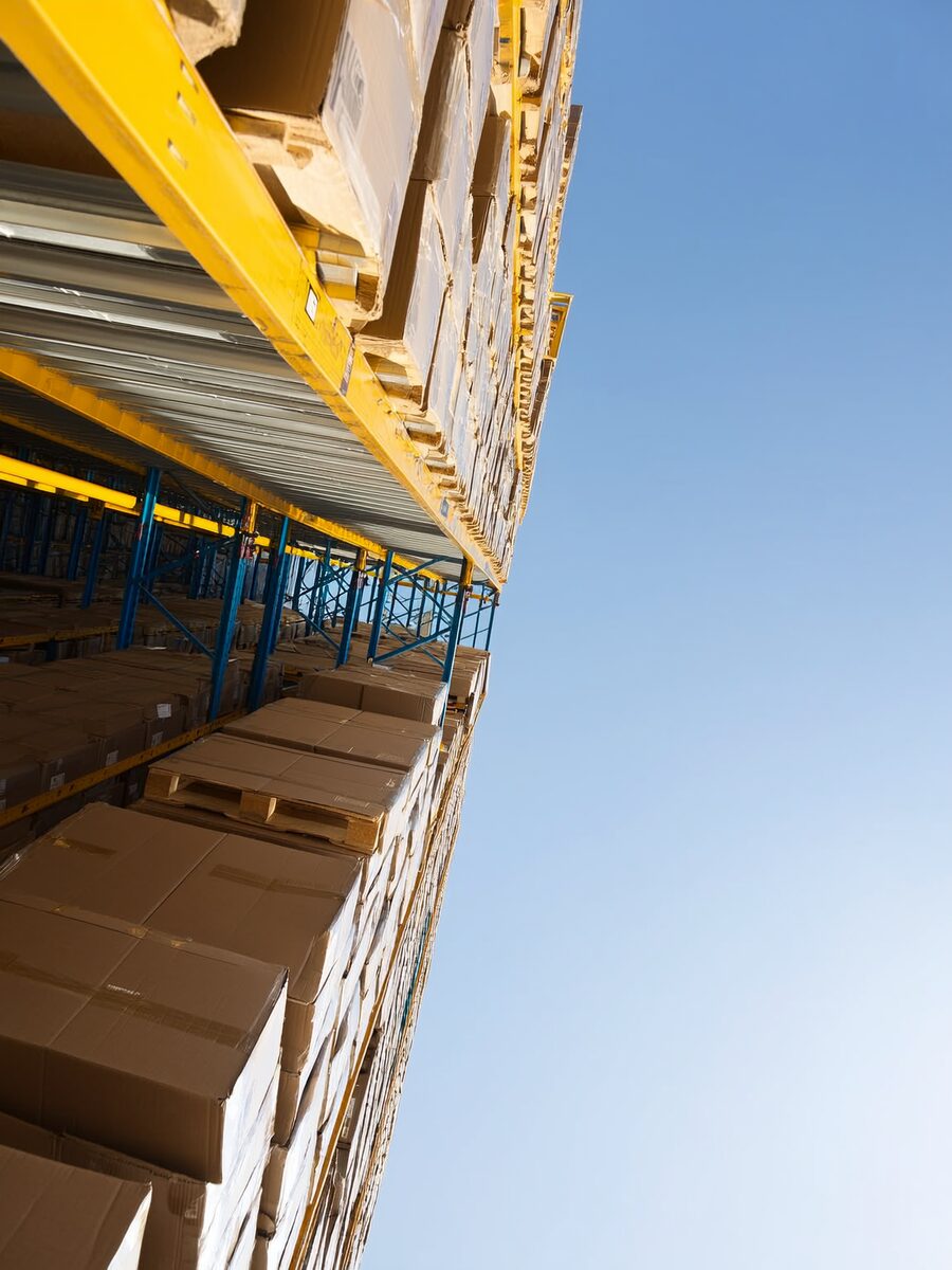 Stacked cartons and pallets in a bright warehouse